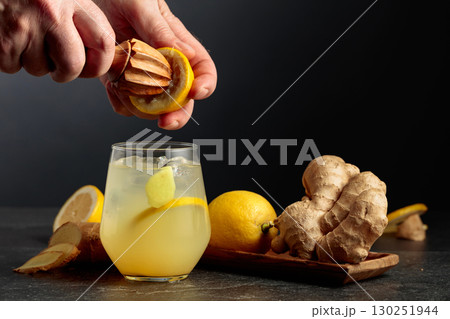 Ginger Ale with ice and lemon on a black background. Ginger Ale with ice and lemon on a black background. 130251944