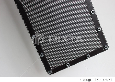 Part of square perforated black panel with steel nuts around the edges  130252071