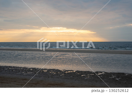 Sunset on the beach near beautiful sea in the evening. Yellow sunlight. Vacation in Ostend, Belgien. 130252612