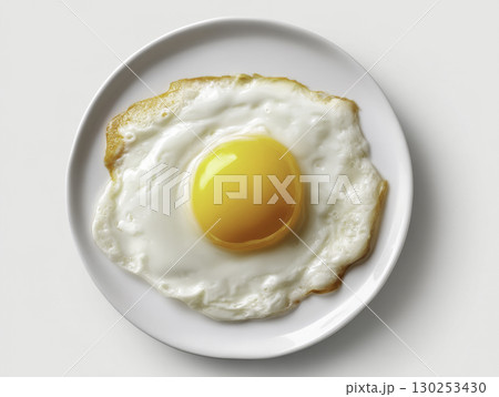 Sunny-side up fried egg with bright yellow yolk on a white plate, close-up, minimalist breakfast concept, healthy protein meal, simple food styling Sunny-side up fried egg with bright yellow yolk on a white plate, close-up, minimalist breakfast concept, healthy protein meal, simple food styling 130253430