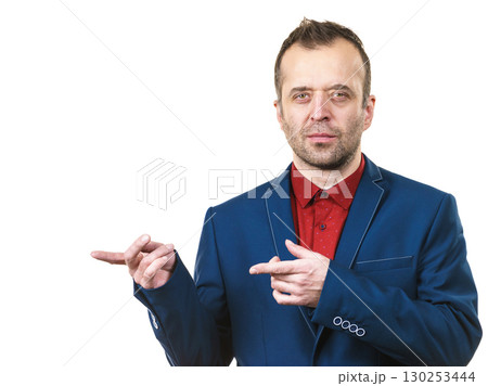 Elegant man in suit pointing on copy space Elegant man in suit pointing on copy space 130253444