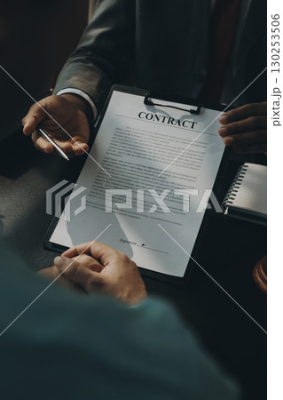Lawyer explained to the client about the law that must be brought against the court case. Lawyer explained to the client about the law that must be brought against the court case. 130253506