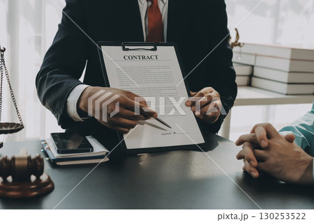Lawyer explained to the client about the law that must be brought against the court case. Lawyer explained to the client about the law that must be brought against the court case. 130253522