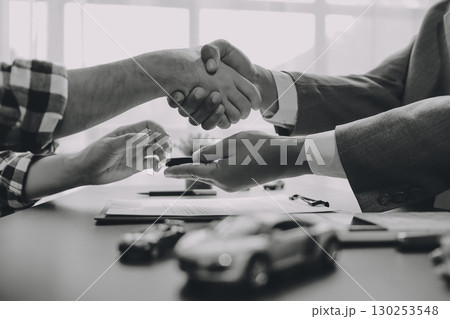 Car salesman gave the keys to the customers who signed the purchase contract legally, Successful completion of car sales, Purchase contract and key delivery. 130253548