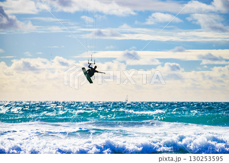 Kite surfer riding waves. Kiteboarding sport. Kite surfer riding waves. Kiteboarding sport. 130253595