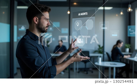 Professional Man Interacting with Virtual Interface of AI Agents in Modern Office 130254491