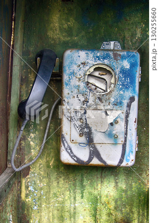 Old broken phone in phone booth. coinbox Old broken phone in phone booth. coinbox 130255660