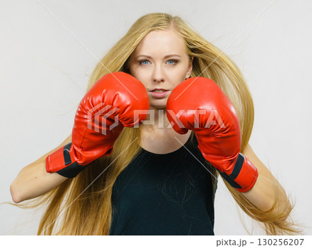 Woman in gloves playing sports boxing Woman in gloves playing sports boxing 130256207