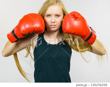Woman in gloves playing sports boxing Woman in gloves playing sports boxing 130256209