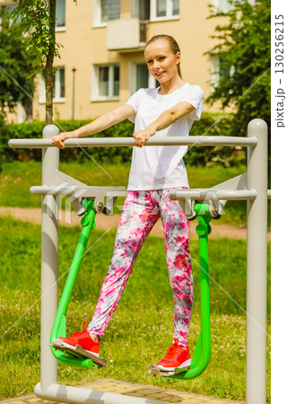 Woman doing exercise in outdoor gym 130256215