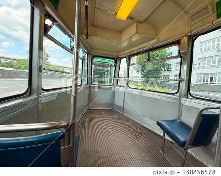 Interior of old retro tram with empty seats. Urban transport, public commuting, and nostalgic travel in European city heritage. 130256578