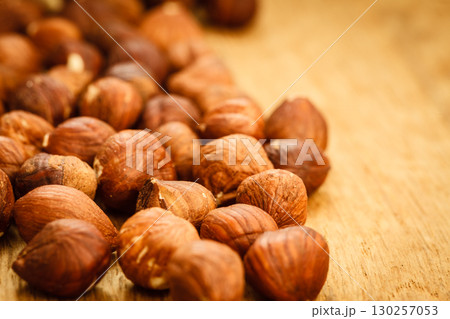 Hazelnuts on rustic old wooden table 130257053