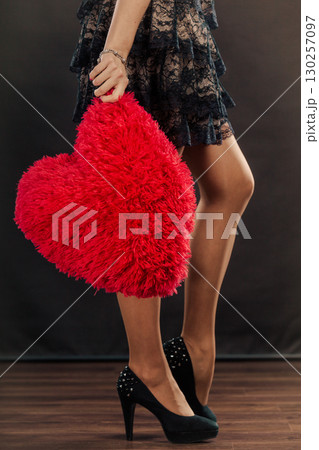 Mature woman holds big red heart Mature woman holds big red heart 130257097