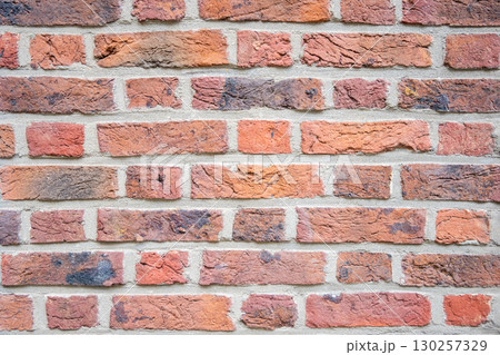 Brown structural stone wall of the ancient building consists of bricks. Nature structural background. Brown structural stone wall of the ancient building consists of bricks. Nature structural background. 130257329