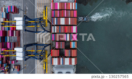 Aerial view container cargo ship at port with tugboat, Business global import export logistic maritime transport by container cargo ship vessel, International trade container cargo freight shipping. 130257565