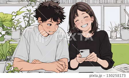 幸せそうに一緒にスマホを見る若いカップル