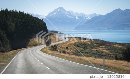 Landscape with curving alpine road, turquoise lake and snowy mountains, Mt Cook, New Zealand Landscape with curving alpine road, turquoise lake and snowy mountains, Mt Cook, New Zealand 130258564