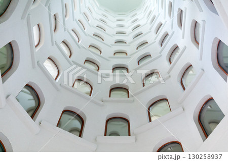 architectural background, spiral staircase with windows opening into a skylight under the dome architectural background, spiral staircase with windows opening into a skylight under the dome 130258937
