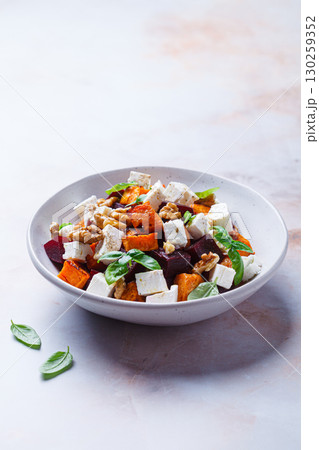 Salad with sweet potato, beetroot, feta and walnuts. 130259352