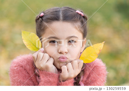 Autumn leaves and nature. Happy little girl in autumn forest. Happy childhood. School time. Small child with autumn leaves. Feeling dry and protected. Going crazy. Lost in thoughts Autumn leaves and nature. Happy little girl in autumn forest. Happy childhood. School time. Small child with autumn leaves. Feeling dry and protected. Going crazy. Lost in thoughts 130259559