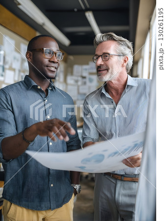 entrepreneur showing sales chart to business mentor in small office 130261195