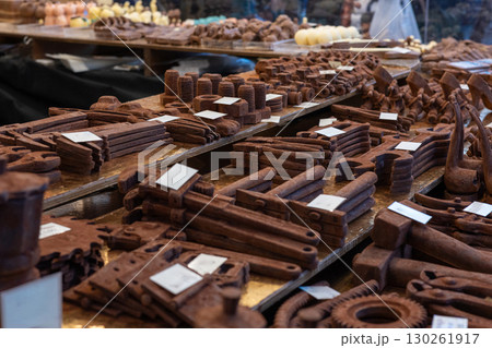 Chocolate tools and nuts displayed on wooden shelves at market stall Chocolate tools and nuts displayed on wooden shelves at market stall 130261917