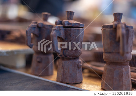 Chocolate moka pots showing italian coffee tradition Chocolate moka pots showing italian coffee tradition 130261919
