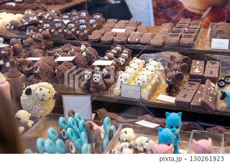 Delicious chocolate figures displayed on shelves at market stall Delicious chocolate figures displayed on shelves at market stall 130261923