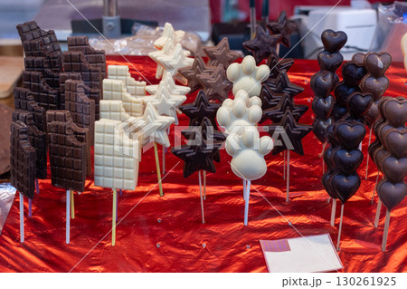 Chocolate lollipops displayed on red foil at market stall Chocolate lollipops displayed on red foil at market stall 130261925