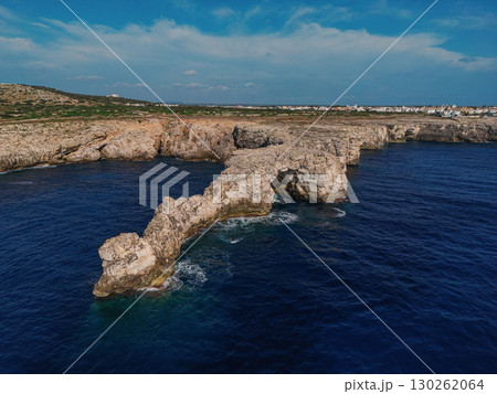 Natural rock arch extending 130262064