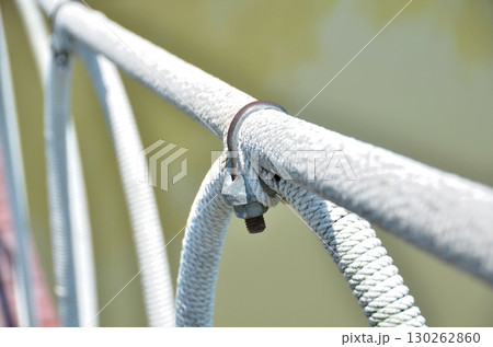 The fastening of ropes with safety locking U-Bolts made for a bridge across the canal. The fastening of ropes with safety locking U-Bolts made for a bridge across the canal. 130262860