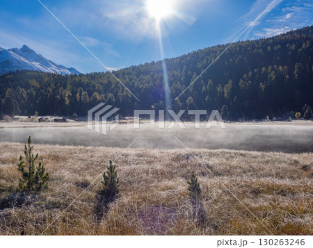 St. Moritz, Switzerland - October 6th 2024: Idyllic lake Lej da Staz in the morning sunlight St. Moritz, Switzerland - October 6th 2024: Idyllic lake Lej da Staz in the morning sunlight 130263246