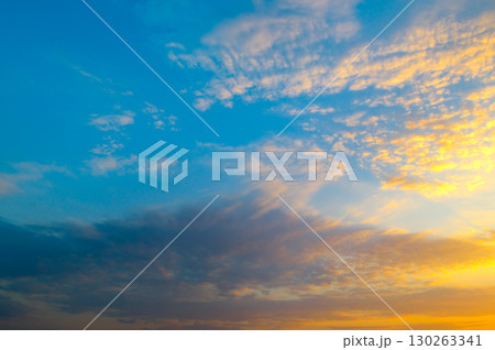Sky with vibrant clouds at sunset, gradient from blue to orange. Sky with vibrant clouds at sunset, gradient from blue to orange. 130263341