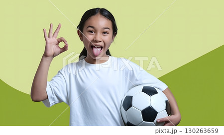 Young Girl with Soccer Ball Making OK Sign 130263659