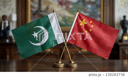 Pakistan and China Flags Displayed Together on Desk 130263736