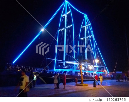 Brightly Lit Boat at Marina Bay in Hurghada Attracts Tourists During a Vibrant Evening Promenade Brightly Lit Boat at Marina Bay in Hurghada Attracts Tourists During a Vibrant Evening Promenade 130263766