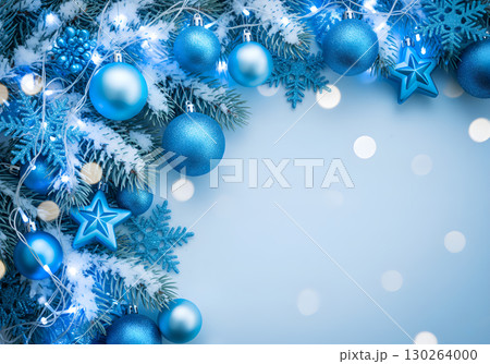 Winter composition with blue and white Christmas balls and snowflakes on a snow-covered branch. Winter composition with blue and white Christmas balls and snowflakes on a snow-covered branch. 130264000