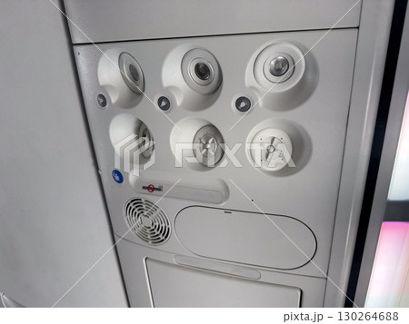 Closeup of airplane cabin panel with air vents and light controls. Passenger service and aviation engineering. Closeup of airplane cabin panel with air vents and light controls. Passenger service and aviation engineering. 130264688