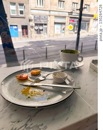 Messy empty plate with food leftovers and coffee cup on marble table. Everyday breakfast moments, lifestyle and dirty table Messy empty plate with food leftovers and coffee cup on marble table. Everyday breakfast moments, lifestyle and dirty table 130264726