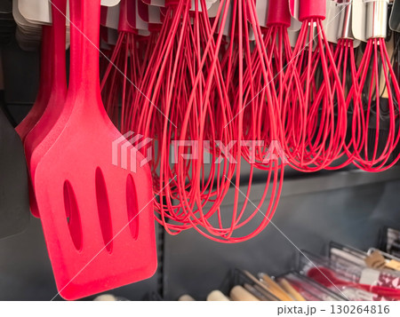 Bright red kitchen utensils arranged neatly on display in a cooking store 130264816