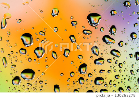 Beautiful multi-colored water droplets on a glass Beautiful multi-colored water droplets on a glass 130265279