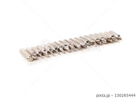 A set of different attachments for a head screwdriver with a screwdriver on a white background 130265444