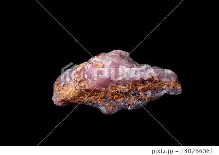 Macro pink Smithsonite mineral stone on microcline on black background 130266061