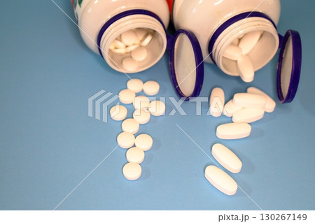 White Pills and Tablets on Blue 130267149