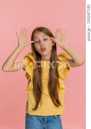 Child girl kid playfully teasing sticking out tongue at camera while making funny silly expressions Child girl kid playfully teasing sticking out tongue at camera while making funny silly expressions 130267185