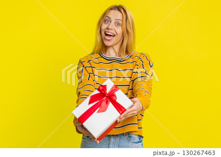 Smiling woman presenting birthday gift present box stretches out hands, promotion discount sale Smiling woman presenting birthday gift present box stretches out hands, promotion discount sale 130267463