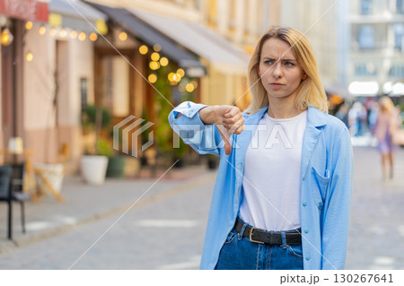 Woman shows thumbs down sign dislike expressing discontent disapproval dissatisfied bad work mistake Woman shows thumbs down sign dislike expressing discontent disapproval dissatisfied bad work mistake 130267641