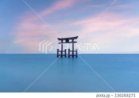 Torii gate stands in Lake Biwa, Japan, under a pastel sky Torii gate stands in Lake Biwa, Japan, under a pastel sky 130268271