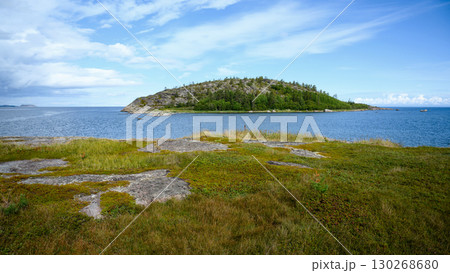 Scenic islands view with lush greenery and water under cloudy sky in White Sea, landscape and nature of Karelia in summer, travel concept. Scenic islands view with lush greenery and water under cloudy sky in White Sea, landscape and nature of Karelia in summer, travel concept. 130268680