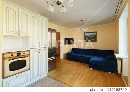 A Modern Kitchen and Living Room Combo Featuring a Cozy Couch for Ultimate Relaxation 130268740